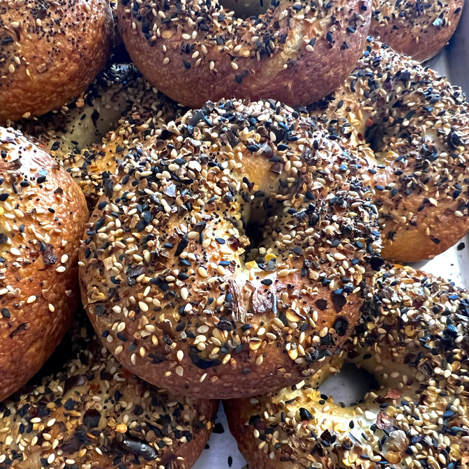 Fresh everything bagels in a pile.